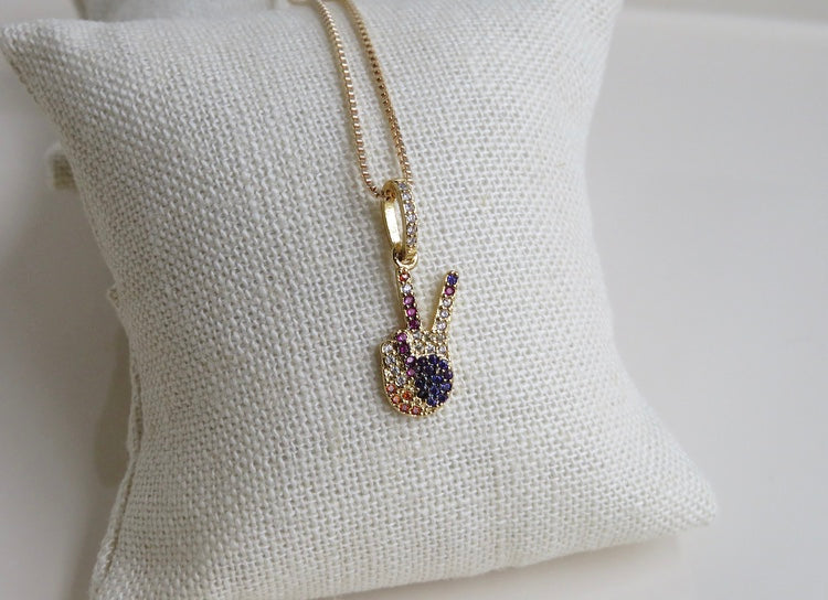 our colorful cubic zirconia peace sign pendant that you can add to our necklaces or add it to your own existing necklace. this is also available to order as a necklace. beautiful colors of purple, pinks, magents, clear and orange. 