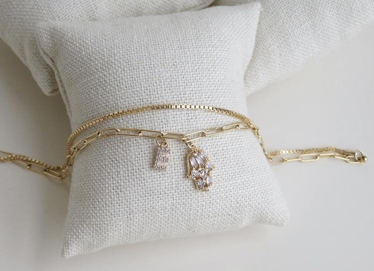 A Beautiful Combination of our Paper Clip and Box Chain, it’s two chains on a single clasp so it’s like a double layer in one.  This Anklet has a diamond hamsa and a petite diamond letters (A-Z). a beautiful Personalized Piece of Jewelry.